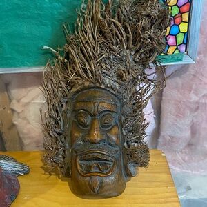 Handcrafted Wooden Tribal Mask with Natural Fibers